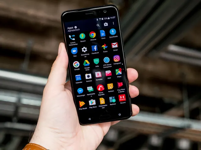 A hand holding a smartphone